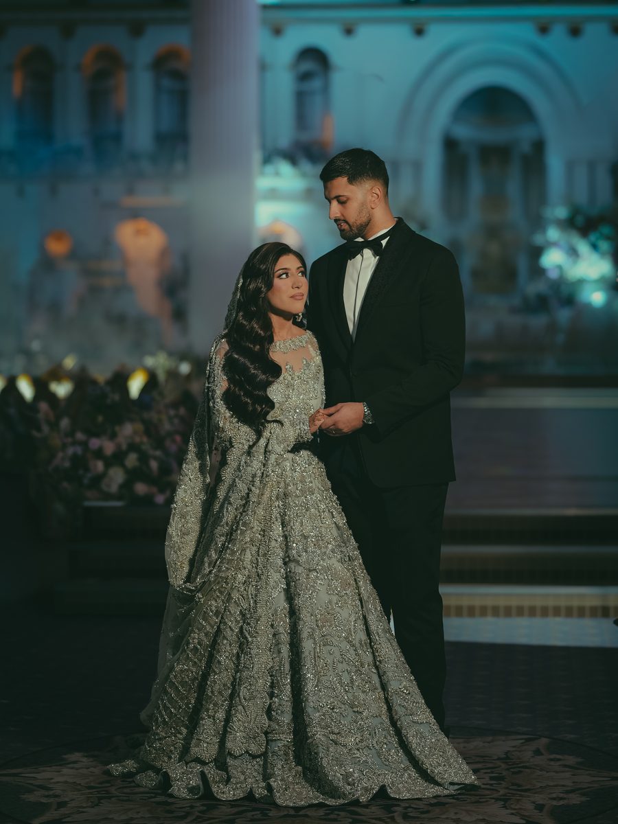 Bride and groom at an evening venue — graded