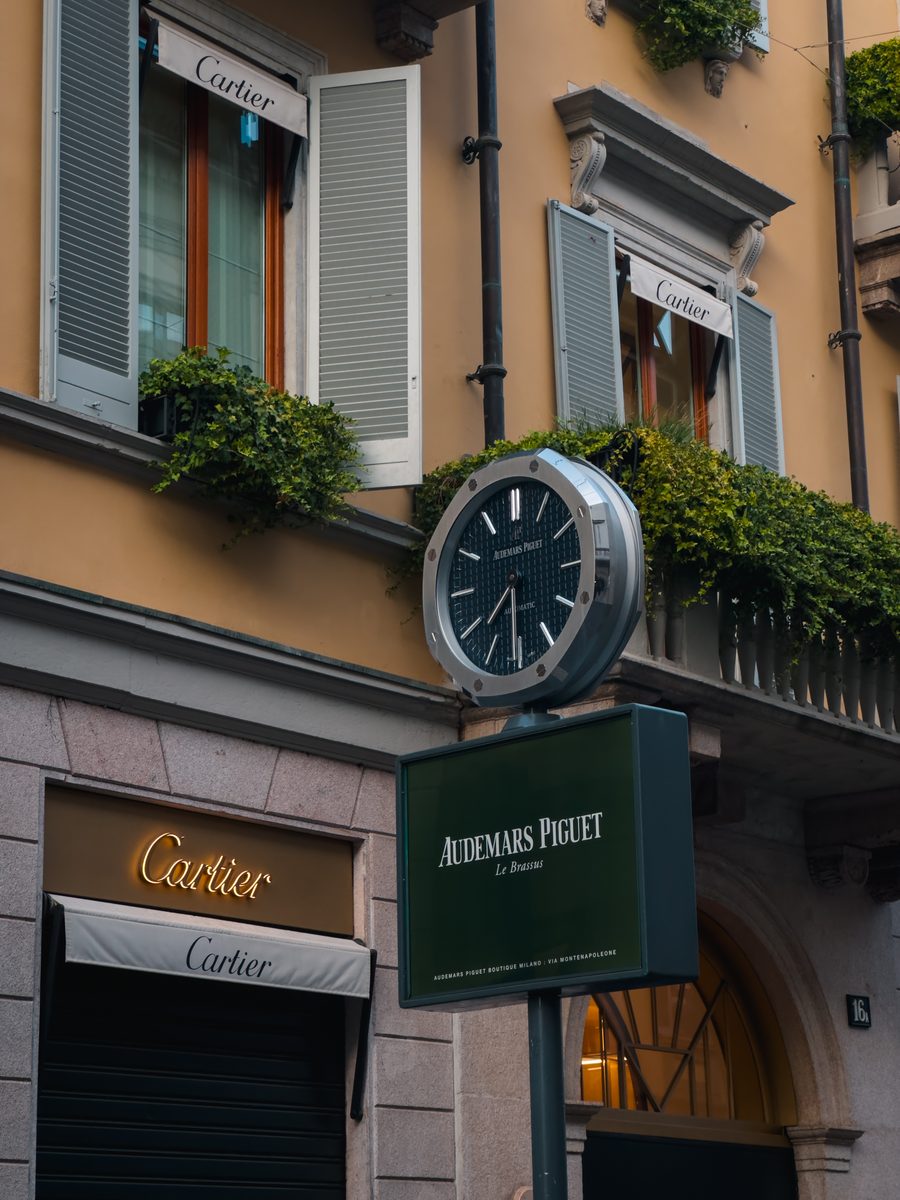 Street clock and boutique facades — graded