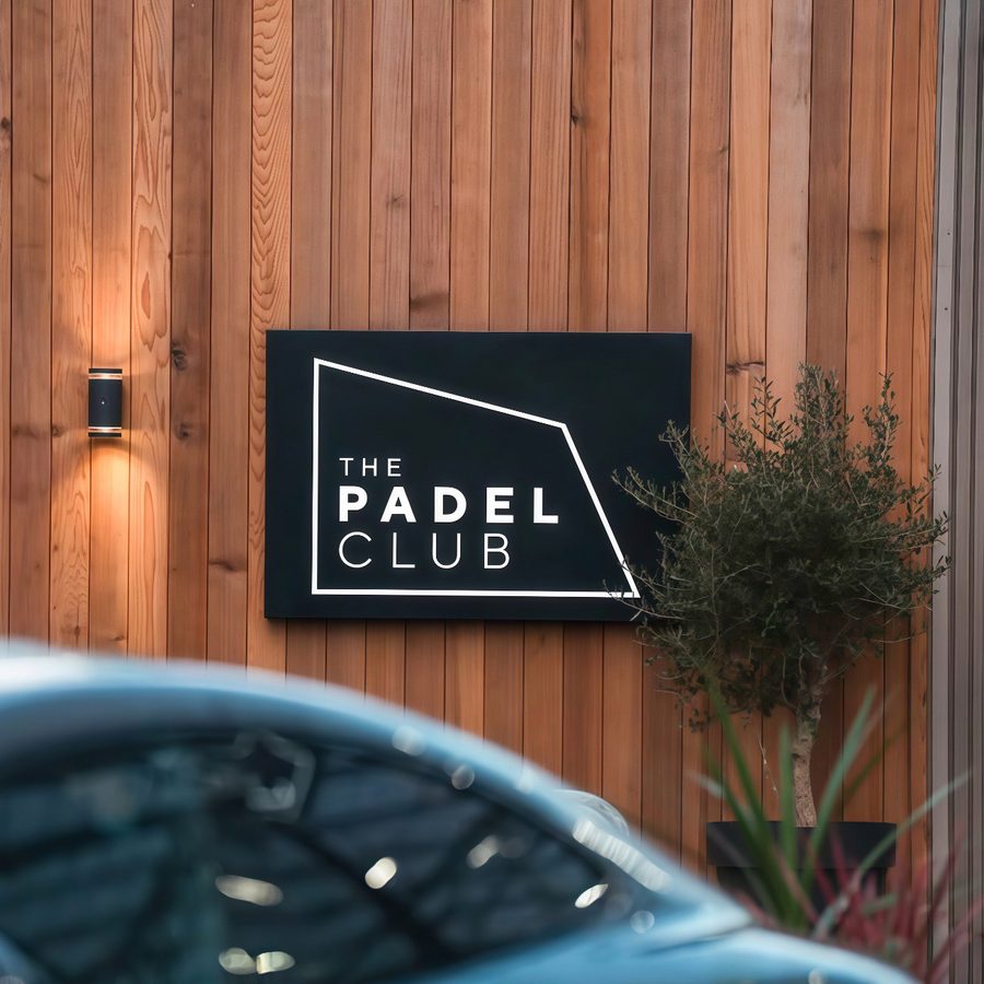The Padel Club signage on a timber-clad wall